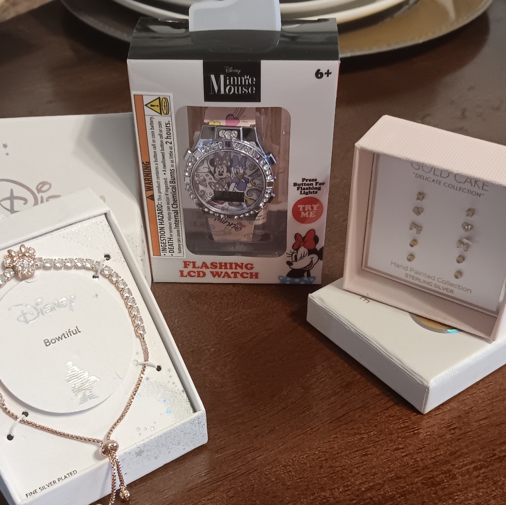 ..Disney jewerly bracelet,5 pair of Gold Cake Earrings, and Minnie Mouse watch.
